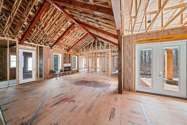 miscellaneous room featuring lofted ceiling and french doors