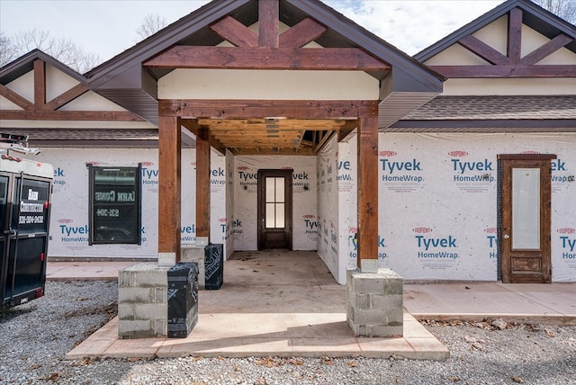 property entrance with roof with shingles