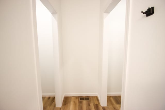 interior space featuring visible vents, baseboards, and wood finished floors