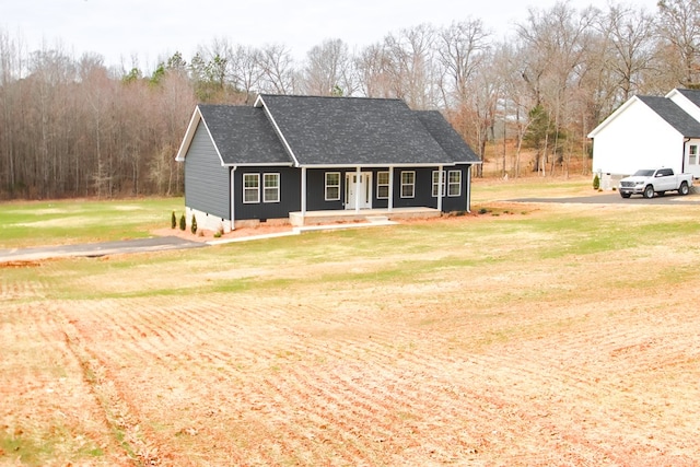 view of front of house with a porch, crawl space, roof with shingles, and a front lawn