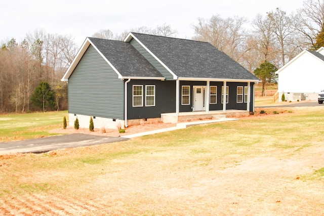 view of front facade featuring a porch, crawl space, a front yard, and a shingled roof