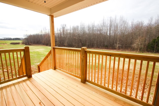 wooden terrace featuring a lawn