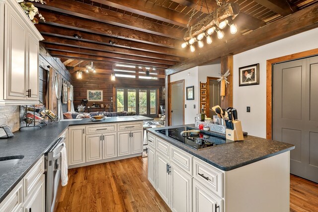 kitchen featuring open floor plan, white cabinets, and black electric cooktop