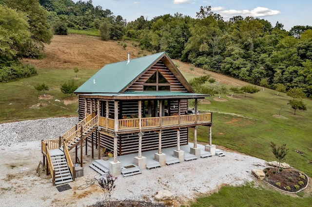 view of front of home with metal roof and stairway