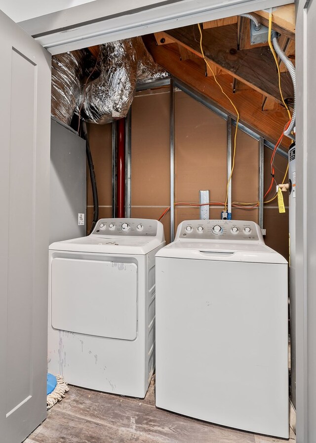 laundry room featuring laundry area, washer and clothes dryer, and wood finished floors