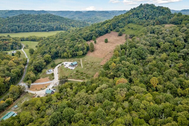 birds eye view of property featuring a wooded view