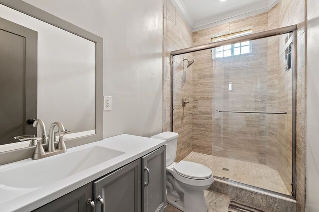 full bath featuring toilet, a shower stall, crown molding, and vanity