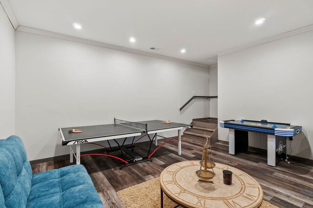 recreation room featuring ornamental molding, recessed lighting, dark wood finished floors, and baseboards