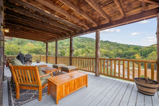 deck with a forest view and a grill