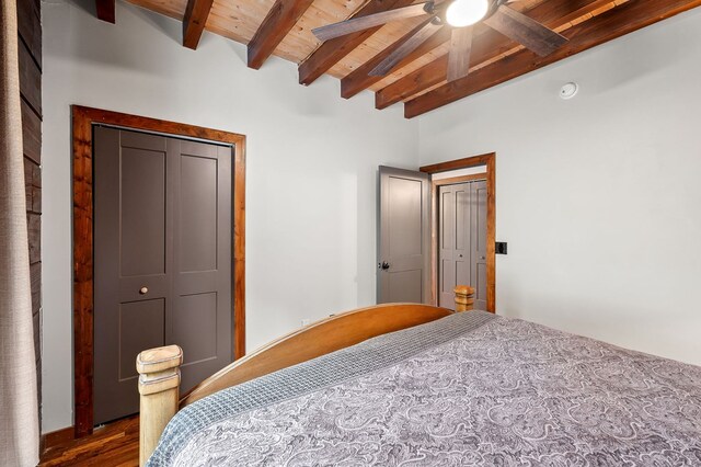 bedroom featuring wood ceiling, dark wood finished floors, ceiling fan, and beam ceiling