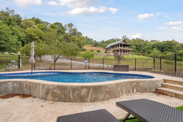 view of pool featuring fence, a fenced in pool, and a patio