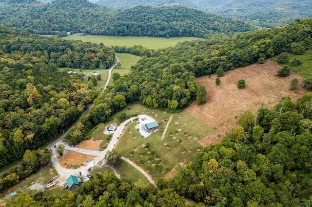 bird's eye view with a wooded view