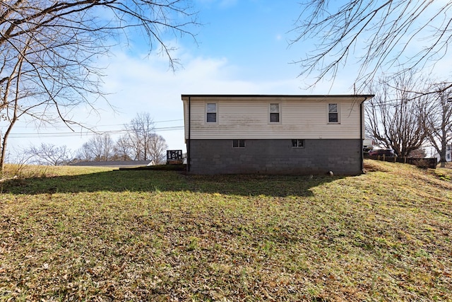 view of side of home featuring a lawn