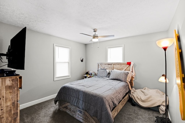 bedroom featuring a ceiling fan, baseboards, dark carpet, and a textured ceiling