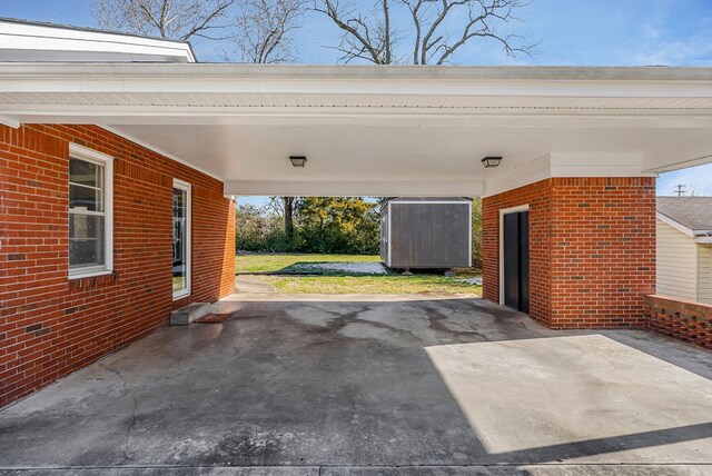 garage featuring an attached carport and a shed