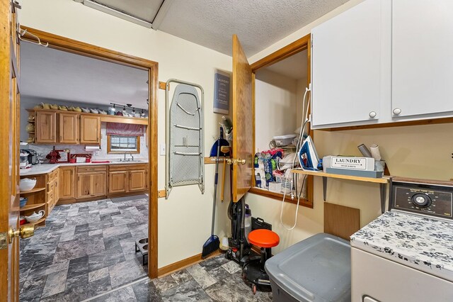 interior space with a sink and washer and clothes dryer