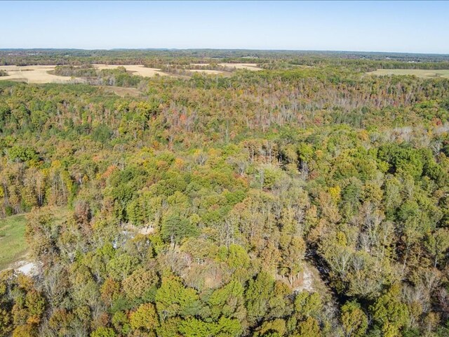 drone / aerial view with a wooded view