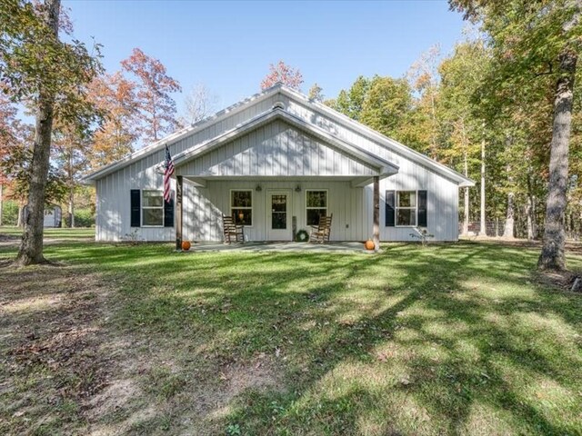 back of house with a lawn