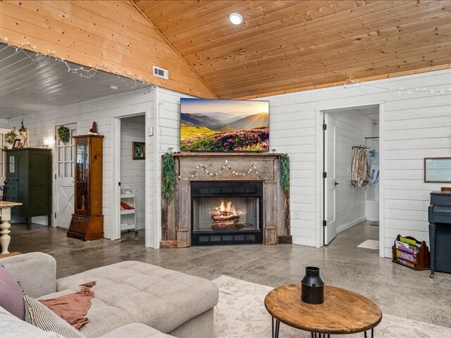 living area featuring wooden walls, visible vents, wood ceiling, high vaulted ceiling, and a high end fireplace