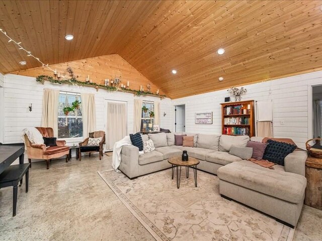 living area featuring high vaulted ceiling, wood ceiling, visible vents, and a premium fireplace