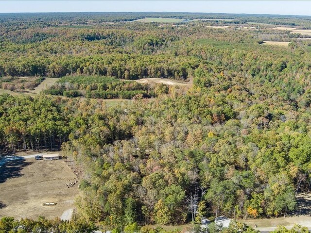 drone / aerial view featuring a view of trees