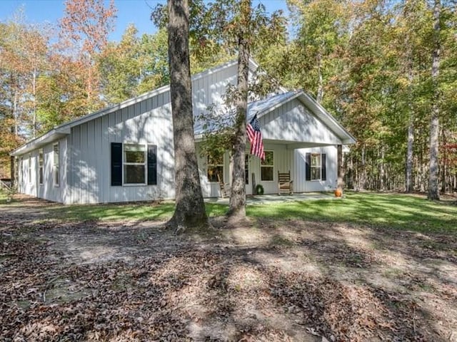 rear view of property with a lawn