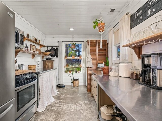 kitchen with visible vents, finished concrete floors, stainless steel appliances, stainless steel counters, and open shelves