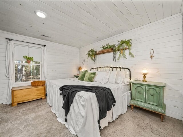 bedroom featuring wood ceiling and wooden walls