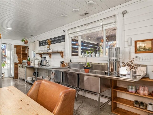 bar with wood walls, wooden ceiling, visible vents, and a healthy amount of sunlight