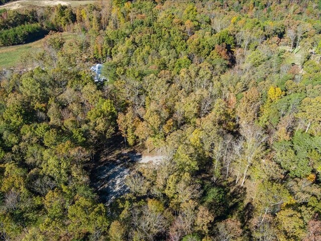 birds eye view of property with a view of trees