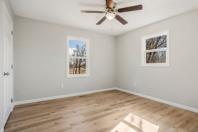 unfurnished room featuring baseboards, light wood finished floors, and ceiling fan