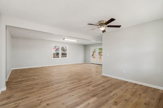 unfurnished living room featuring ceiling fan, light wood-type flooring, and baseboards