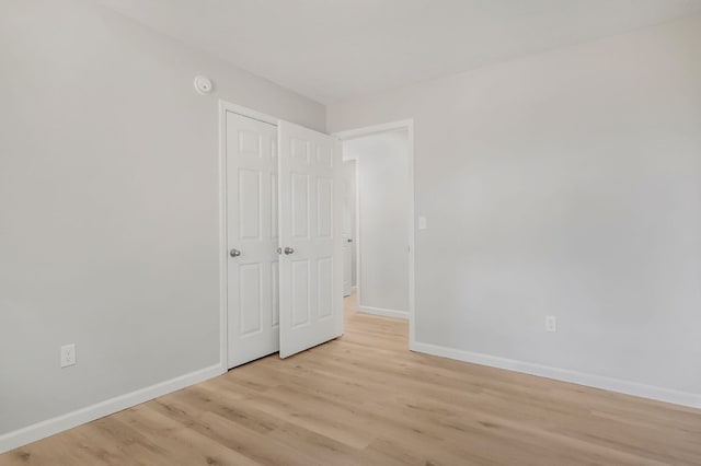 unfurnished bedroom featuring baseboards and light wood-style floors