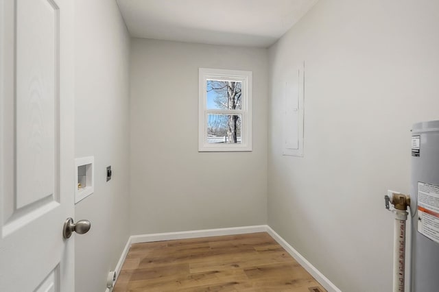 laundry room featuring laundry area, baseboards, light wood-type flooring, and hookup for an electric dryer