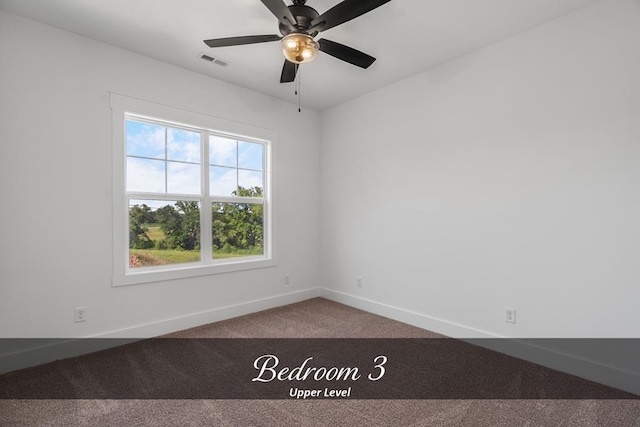 carpeted empty room with baseboards, visible vents, and ceiling fan