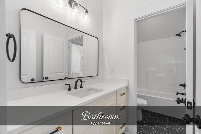 bathroom featuring toilet, tile patterned flooring, washtub / shower combination, and vanity