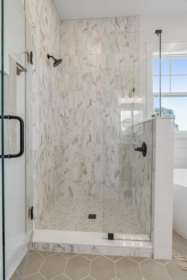 bathroom featuring a soaking tub and a shower stall