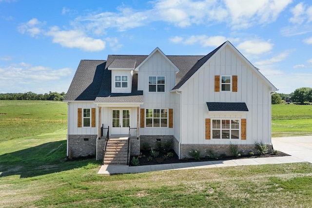 modern inspired farmhouse with crawl space, roof with shingles, board and batten siding, and a front yard