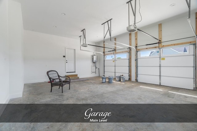 garage featuring water heater, baseboards, and a garage door opener