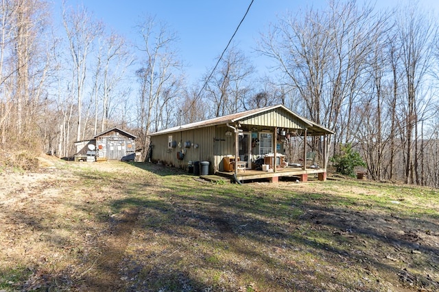 exterior space with an outbuilding and a lawn