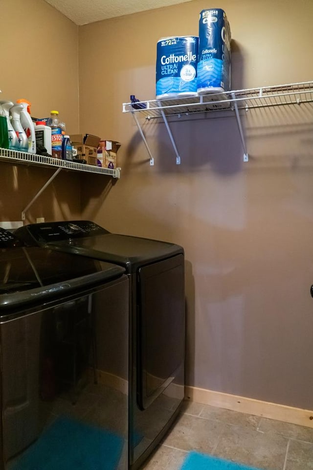 laundry room featuring laundry area, washer and clothes dryer, and baseboards