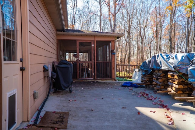 view of patio featuring area for grilling and a sunroom