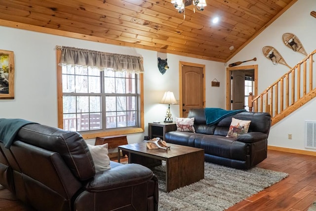 living area featuring vaulted ceiling, wood finished floors, wooden ceiling, baseboards, and stairs