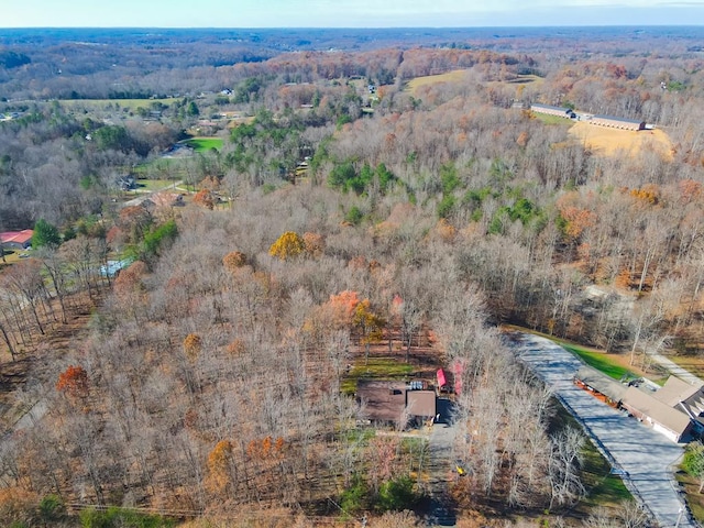 birds eye view of property featuring a view of trees