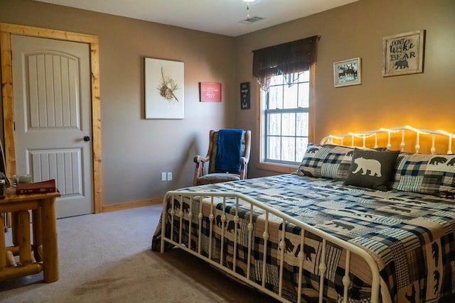 carpeted bedroom featuring visible vents and baseboards