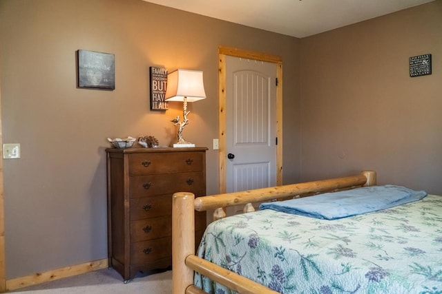 bedroom with light carpet and baseboards