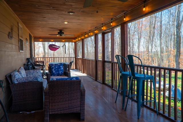 sunroom / solarium with wooden ceiling and ceiling fan