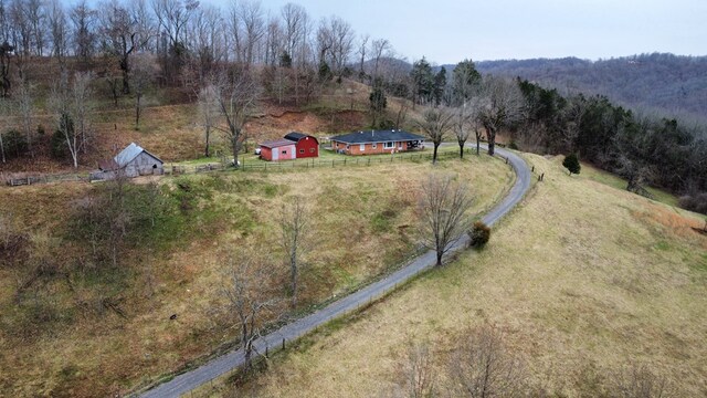 drone / aerial view featuring a wooded view and a rural view