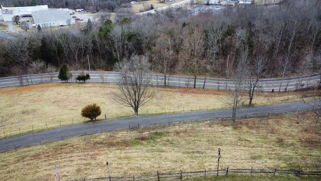 view of yard featuring a rural view and fence