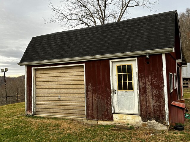 exterior space featuring an outdoor structure and fence